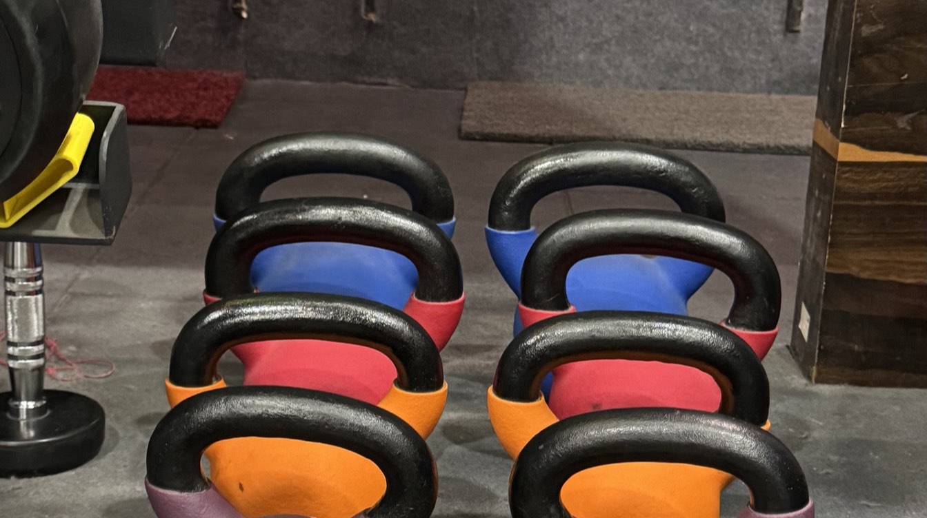 Rows of colour-coded kettlebells on the Moves n Stretch studio floor